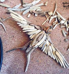 a bird made out of wood sticks and other items