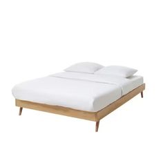 an image of a bed with white sheets and wooden headboard on the bottom side