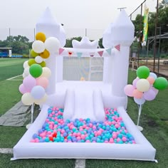 an inflatable ball pit with balloons and streamers