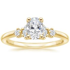 a yellow gold engagement ring with an oval cut diamond and two small round diamonds on the band