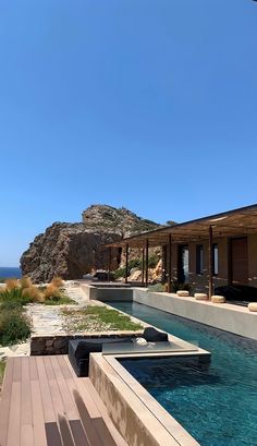 an outdoor swimming pool next to the ocean