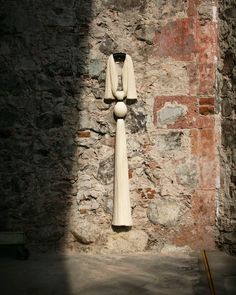 a statue is shown against a stone wall