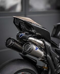 a close up view of the engine and exhaust system on a motorcycle