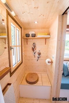 small bathroom with wooden walls and flooring in the cabin style home or office area