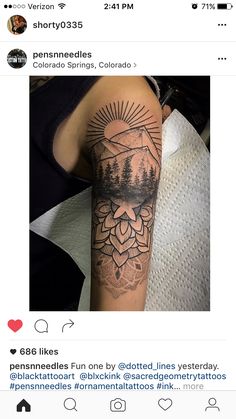 a person with a tattoo on their arm that has trees and mountains in the background