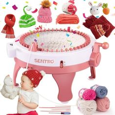 a baby sitting on the ground next to a pink machine with hats and knitting needles