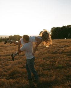 a man carrying a woman on his back in the middle of a large open field