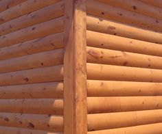 the corner of a log cabin with wood slats