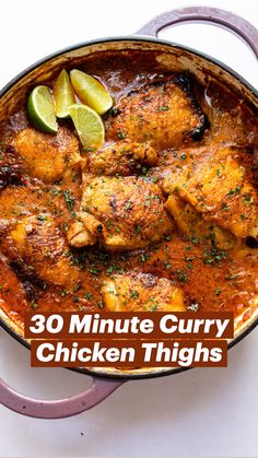 chicken curry in a pan with limes on the side