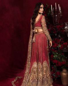 Royal Pakistani Bridal Dress in Red Lehnga Choli Style is a magnificent masterpiece hand-embellished with pearls, sequins, and crystals. Embroidery, dabka, and gota give a stunning touch to this perfectly stitched Lehenga Dress, making it your foremost priority for the big day. Choli: The perfectly stitched choli in a graceful red shade looks beautiful when paired with a Bridal Lehenga. Hand-crafted details of naqshi, dabka, and embroidery give a royal touch to the choli. Goldwork and intricate designs give an exquisite look to the red choli. Lehenga: Bridal Lehenga has a huge flare and it gives the gorgeous bride a breathtaking appearance. Pearls, sequins, and crystals give a glamorous look to the Red Lehnga. Tilla, dabka, gota, and goldwork enhance the charm of this Bridal Lehenga dress, Choli Style, Lehenga Dress, Red Lehenga Choli, Pakistani Bridal Dress, Lehenga Bridal, Stitched Lehenga, Raw Silk Fabric, Indian Bridal Lehenga, Red Lehenga