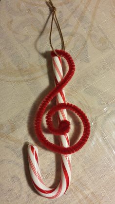 a red and white christmas ornament hanging from a string