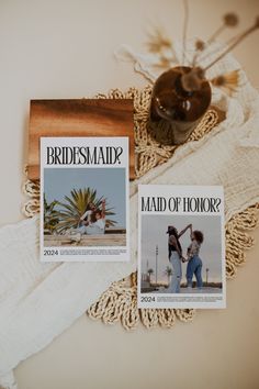 two bridesmaids magazine covers sitting on top of a lace doily next to a vase