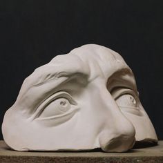 a sculpture of a man's face with his eyes wide open