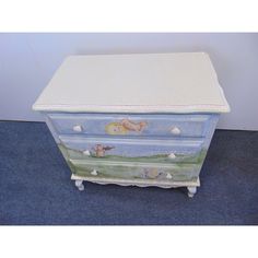 an old dresser has been painted with animals and seashells on the bottom drawer