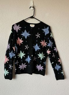 "Women's blue  sweater  Purple. green, pink and light blue stars Button closure Material - 44% cotton, 42% ramie and 14% linen Measurement - shoulder 16\" armpit to armpit 19.5\" sleeve 24\" length 23.5\" Condition is great" Long Linen Pants, Snowflake Sweater, Star Buttons, Green Cargo Pants, Xmas Sweater, Blue Stars, Wool Shawl, Blue Sweater, Blue Christmas