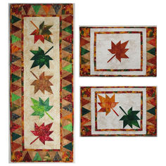 two quilted wall hangings with autumn leaves on the front and one in the back