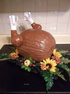 a cake shaped like a turkey sitting on top of a stove