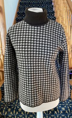 This classic sweater features an all-over houndstooth pattern in chocolate brown and camel, a ribbed fold-over turtleneck, and brown tipped cuffs and hem.  Substantial weight knit.  Very good vintage condition.  Made in Hong Kong.  Dry clean. 100% Merino Wool Label says size XL but seems like a modern size M.  Does not feel like it was shrunken. Bust Body Length Sleeve Length Classic Sweater, Pullover Outfit, Houndstooth Pattern, Women Pullover, Pullover Sweaters, Length Sleeve, Merino Wool, Sweater Outfits, Jumper