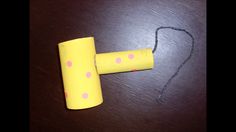 a yellow tube with pink polka dots on it sitting on a table next to a string