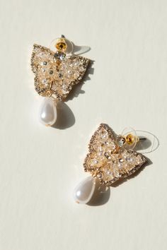 Add a touch of whimsy to your jewelry collection with these 14K gold plated stud earrings, featuring a jeweled butterfly and gorgeous pearl drop. These earrings are not only playful and chic but also nickel-free for sensitive ears. Flutter away in style with our new favorite accessories! Elegant Gold Earrings With Butterfly Charm, Gold Butterfly Charm Earrings For Party, Party Earrings With Gold Butterfly Charm, Gold Earrings With Butterfly Charm For Party, Gold Butterfly Earrings For Wedding, Gold Butterfly Earrings For Party, Party Earrings With Butterfly Charm, Wedding Drop Earrings With Butterfly Charm, Dress In Fall