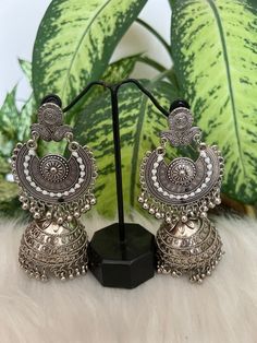 Silver -Toned dome shaped jumkas,silver plated secured with post and back . Material:-Brass  Style tips:- Match this silver plated pair with a maxi or flared dress for you next lunch date . Jumkas Silver, Silver Metal Jhumkas With Latkans, Silver Jhumkas For Festival, Silver Dangle Jhumkas For Festival, Elegant Silver Jhumkas For Festival, Vintage Jhumkas For Wedding, Silver Dangle Earrings With Bells, Silver Metal Jhumkas For Party, Silver Metal Dangle Jhumkas