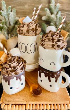 two coffee mugs with chocolate frosting and marshmallows