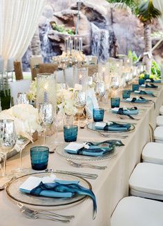 a long table set with blue and white place settings