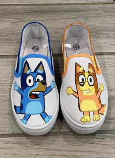 two children's shoes with cartoon characters painted on them