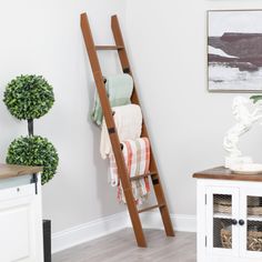 a ladder leaning up against the wall in a room with white walls and wood floors