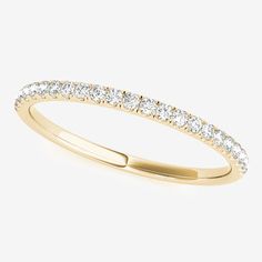 a yellow gold wedding ring with diamonds on it's sides and the top half