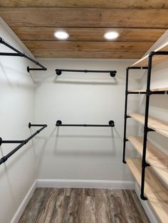 an empty walk in closet with shelves and lights