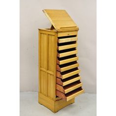 a tall wooden cabinet with many drawers