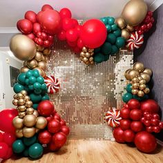 a room decorated with balloons, candy canes and streamers in red, green, gold and white colors