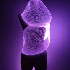 a purple light is shining on a mannequin's torso