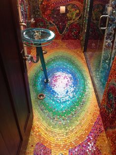 a bathroom with colorful tiles on the floor