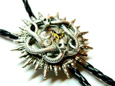 "Sun Steampunk Bolo Tie Snakes, silver or golden, with green emerald eyes, honeymoon surprise, bola fashion silver steam punk accessory clockwork, unique birthday gift mens jewelry. Black leatherette cord and moon metal pendants. Unique birthday gift, honeymoon surprise, wedding, Valentine's Day, Father's Day. Size of about 1 1/2\" / 4 cm diameter of the solar disk Length of the cord 40\" / 100 cm (including metal pendants) Made to order! more Bolo ties: https://www.etsy.com/shop/EmilySteampunk? Symbolic Jewelry With Steel Shank As Gift, Silver Fantasy Jewelry For Festivals, Themed Silver Stainless Steel Jewelry, Steampunk Gold Jewelry For Festivals, Steampunk Jewelry With Adjustable Chain For Gift, Silver Steampunk Jewelry For Party, Steampunk Jewelry With Adjustable Chain As Gift, Steampunk Round Jewelry For Formal Occasions, Gold Steampunk Jewelry For Festival