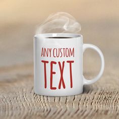 a white coffee mug with the words any custom text on it is sitting on a wooden table