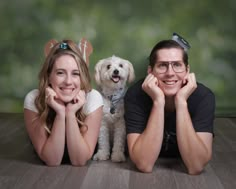 two people and a dog posing for a photo