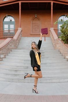 a woman is standing on the steps with her hand in the air