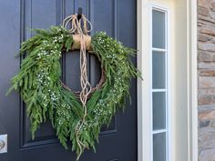 a wreath hanging on the front door of a house