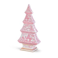 a pink and white christmas tree sitting on top of a table