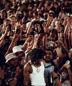 a group of people taking pictures with their cell phones