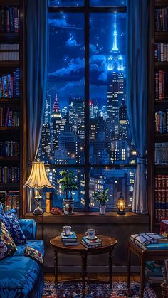 a living room filled with furniture and a large window overlooking the city lights at night