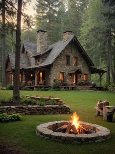 a stone house with a fire pit in the front yard and trees on both sides