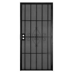 an iron door with bars on the side and a glass paneled door in black