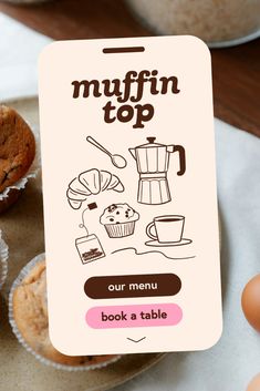 a sign that says muffin top on it next to some cupcakes and muffins