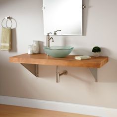 a bathroom sink sitting on top of a wooden counter