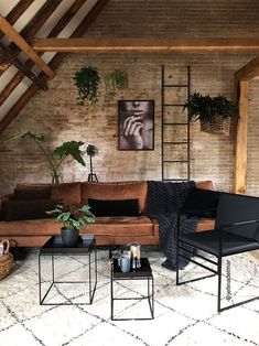 a living room filled with furniture and plants