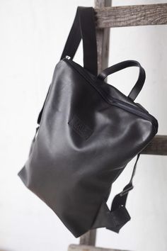 Casual minimalist black leather backpack. Light, comfortable and made from up-cycled materials.Minimalist leather backpack is made from recycled leather. Zip it and you will find natural lining with open and zipped pocket inside.Clutch is also made from upcycled leather. Accessorized with zipper and fabric lining, and big enough for your must-carry items. Measurements 18x24 cm (7x9.5 inches)LeaF leather backpacks are very light and not overloads your back.Minimalist design leather backpack fits Small Black Leather Backpack, Leather Backpack Black, Backpack Fits, Convertible Backpack Purse, Upcycled Bag, Simple Backpack, Grey Backpacks, Minimalist Backpack, Leather Backpack Purse