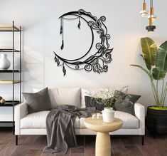 a living room with a white couch and a black clock on the wall above it